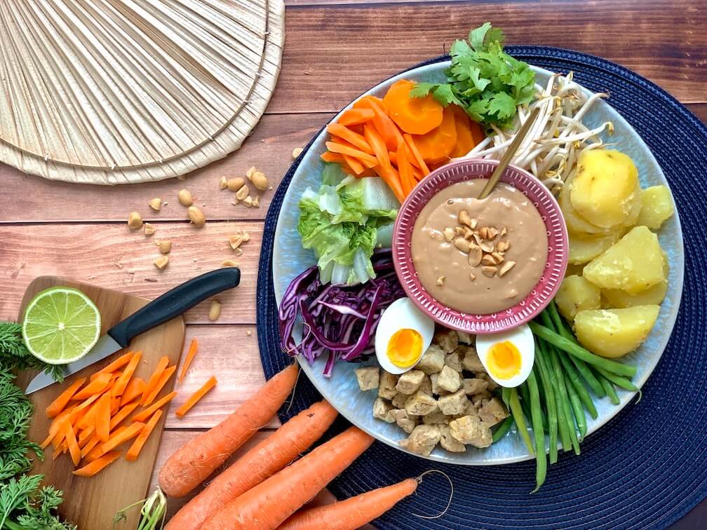 Indonesian Gado Gado with tempeh, green beans, potatoes, mung bean sprouts, carrots, chinese cabbage, red cabbage, peanut sauce, egg