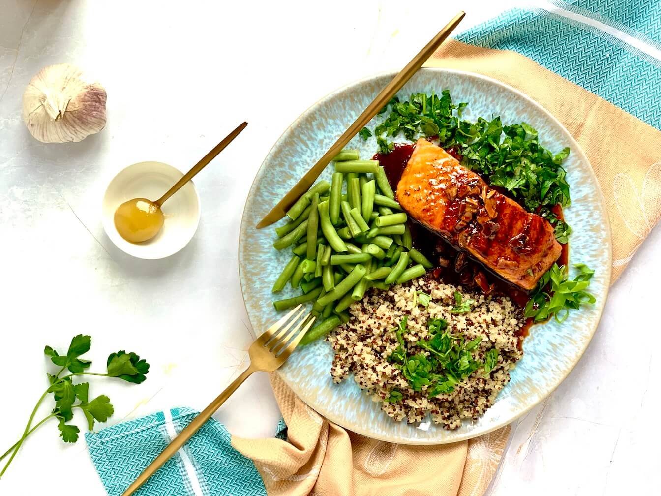 salmon with cooked with garlic and maple syrup, served with quinoa and French beans